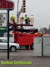 workers putting up sign in wintry mix workers putting up sign in wintry mix